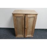 An antique pine double door cabinet