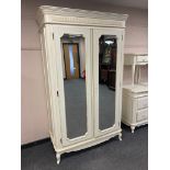 A Laura Ashley cream double mirror door wardrobe,
