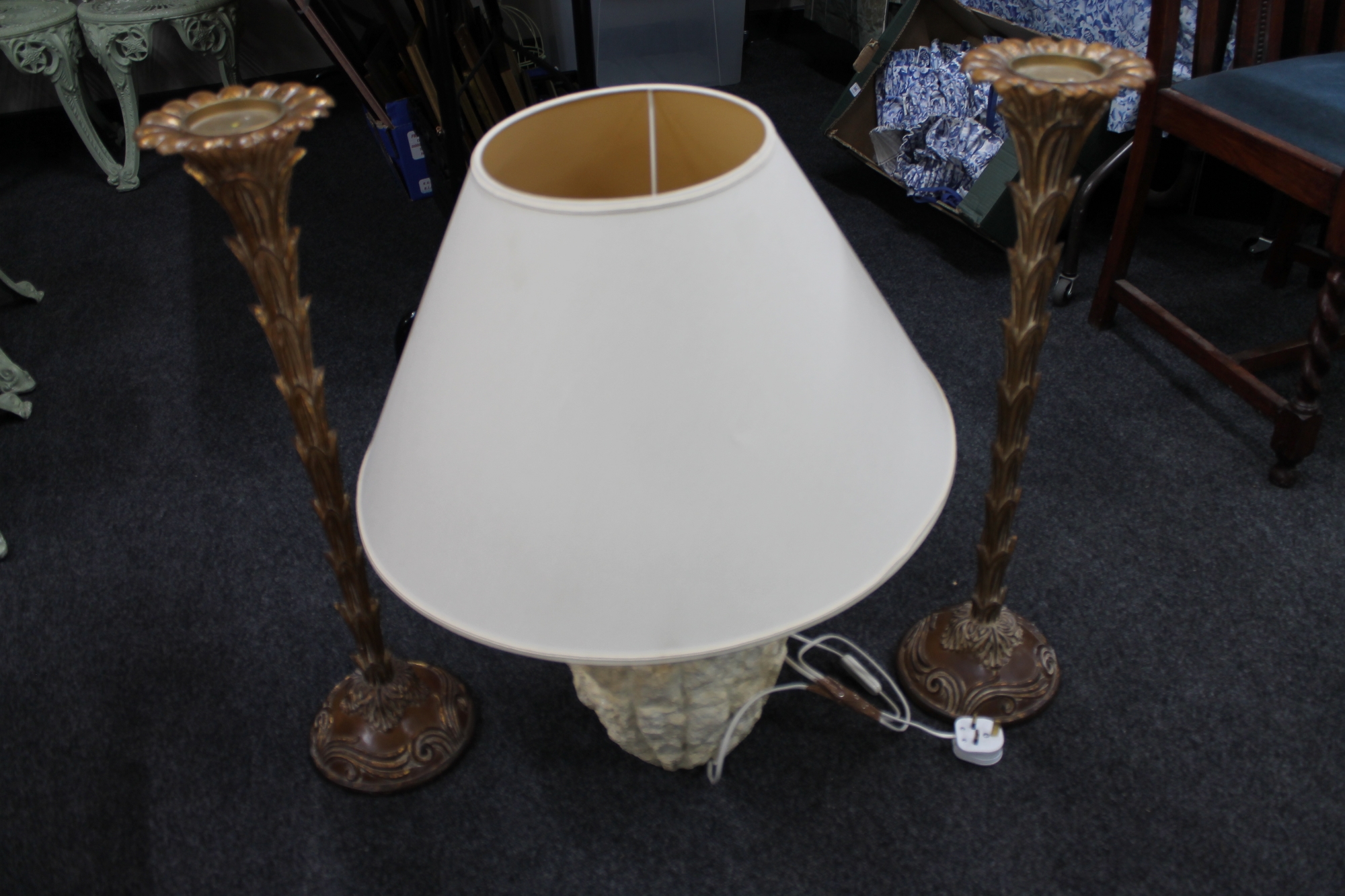 A stone effect Grecian style table lamp with shade together with a pair of gilt wood candle holders