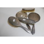 A box of five silver backed dressing table hand mirrors and brushes