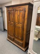 A rustic French double door cabinet fitted with two drawers,