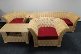 A four piece cane conservatory suite with loose scatter cushions