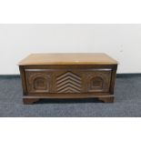 A carved oak blanket box