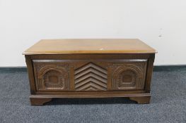 A carved oak blanket box