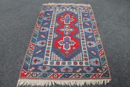 A fringed Caucasian rug of geometric design