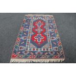 A fringed Caucasian rug of geometric design