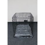A folding metal dog cage width 67 cm