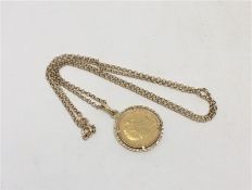 An 1885 gold mounted full Sovereign on 9ct gold chain, 15g gross.