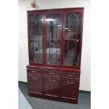 A mahogany effect triple door display cabinet