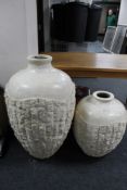 A pair of stone effect Grecian style floor standing vases