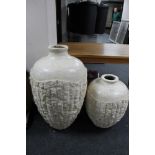 A pair of stone effect Grecian style floor standing vases