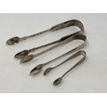 A pair of Georgian silver sugar tongs and two silver Victorian pairs (3) CONDITION