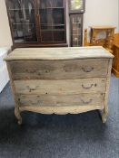 An antique style pine serpentine fronted three drawer chest