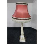 A cream carved table lamp with tassel shade