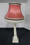 A cream carved table lamp with tassel shade