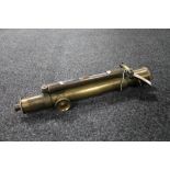 A vintage brass scope with spirit level by T.B.