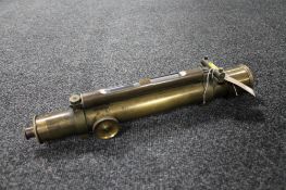 A vintage brass scope with spirit level by T.B.