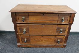 An antique pitch pine three drawer dressing chest (lacking mirror back)