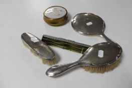 A four piece silver backed dressing table set,
