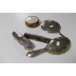 A four piece silver backed dressing table set,