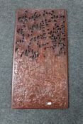 A carved Indonesian hardwood panel