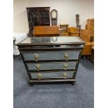 An Empire style mirrored three drawer chest with lion mask handles