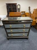 An Empire style mirrored three drawer chest with lion mask handles