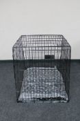 A folding metal dog cage width 67 cm