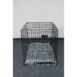 A folding metal dog cage width 67 cm