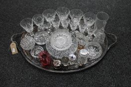 An antique silver plated twin handled tray of drinking glasses, cruets part sets,