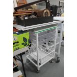 A metal medical trolley with adjustable top fitted two plastic trays and wire mesh tray