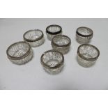Seven cut glass silver rimmed salts