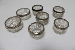 Seven cut glass silver rimmed salts