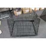 A folding metal dog cage width 94 cm with divider