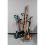 A plastic tub containing gardening tools, two electric strimmers,