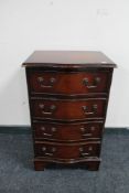 An inlaid mahogany serpentine fronted four drawer chest
