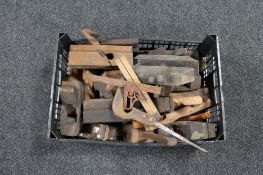 A plastic crate of vintage wood working tools, wood planes, hand saw, vices,