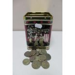 A metal tin of pre decimal British coins and foreign coins