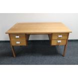 A mid 20th century teak desk fitted with four drawers