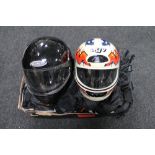 Two motorbike helmets together with a two piece protective suit