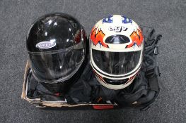Two motorbike helmets together with a two piece protective suit