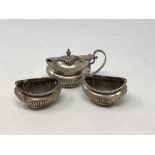 A three piece silver condiment set,