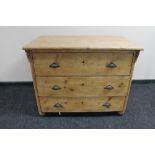An antique pine three drawer chest