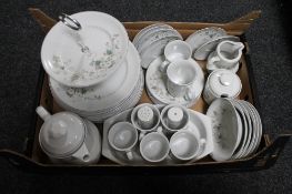 A box of foreign floral and white tea and dinner service