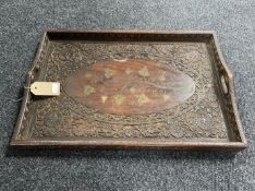 A carved Indonesian hardwood tray with brass inlay