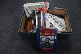A box of books relating to war and images of war magazines in folders