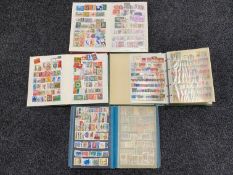 Four stamp albums containing twentieth century stamps of the world