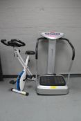 An Marcy vibro plate together with a Davina exercise bike