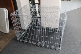 A folding metal dog cage with tray