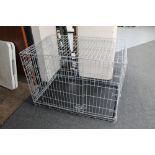 A folding metal dog cage with tray